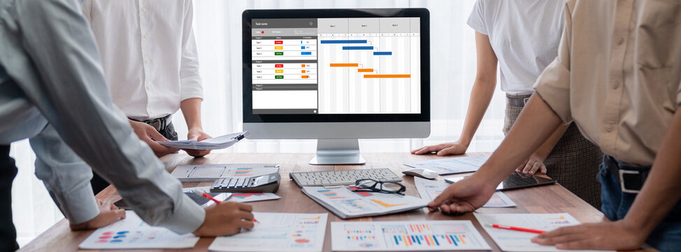 Project planning software for brisk business project management on the computer screen showing timeline chart of the team project