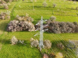 Aerial View of High Voltage Power Line Tower in Green Landscape