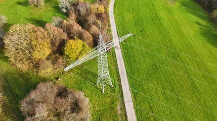 Aerial View of High Voltage Power Line Tower in Green Landscape
