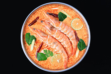 Tom Yum Kung or Tom Yum Goong a Spicy Sour Soup on wooden table top view, Food photography for use in menus