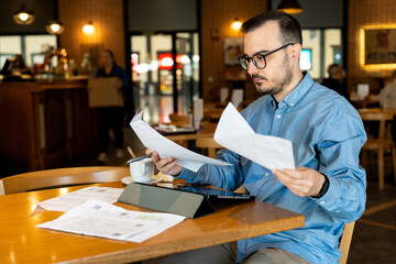 Man reviewing financial statements and business documents