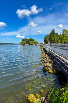 A peaceful walk unfolds along the Ternopil Pond in Ternopil, Ukraine, where calm waters and lush surroundings create a serene urban retreat.
