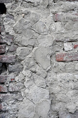 Old brick wall texture with rough plaster coating showing signs of wear and age