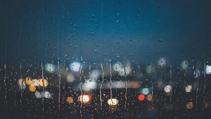 Rainy night city lights bokeh through wet window glass water droplets streaking down glass - Powered by Adobe