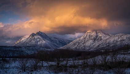 Dramatic sunset clouds during a winter storm over Beinn Toaig and Stob A'Choire Odhair peaks, erosion risk