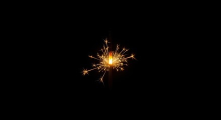 Fototapeta premium Glowing sparkler on black background: bright fireworks effect