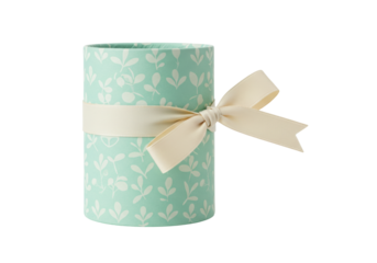 Isolated cylinder-shaped box with pale green leafy pattern and cream ribbon for present packaging