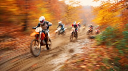 Motocross racer on an off-road motorcycle on a dirt track through an autumn forest. Thrilling sport event with speed and competition.