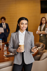 Professional woman engaging in a business meeting setting with colleagues in modern office