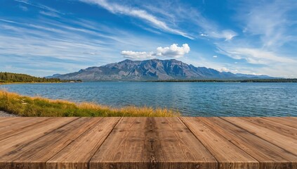 Obraz premium Wooden table overlooking a lake with mountains and a clear blue sky, ideal for nature appreciation