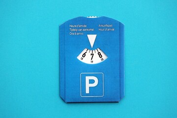 Parking disc for windshield. Limited time parking system in european countries. Concept of parking time count in busy parking lots
