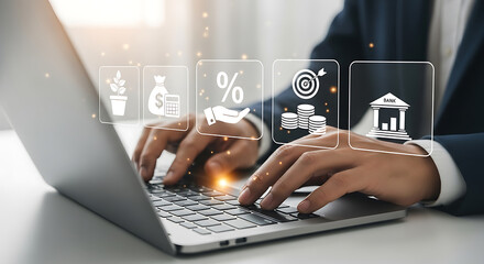 Business man types on a laptop with financial investment icons appearing above the keyboard.