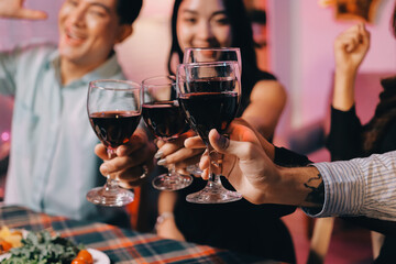 Diversity, dinner and group of people toast celebration together at party. Friends, happy and celebrate with food, wine and friendship for love, support and cheers champagne at business function