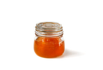 Sweet pumpkin-orange marmalade or confiture in a small jar on a white background. Isolated. Golden pumpkin jam