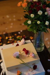 Bouquet of Roses, Gift Boxes, and Petals for a Romantic Proposal