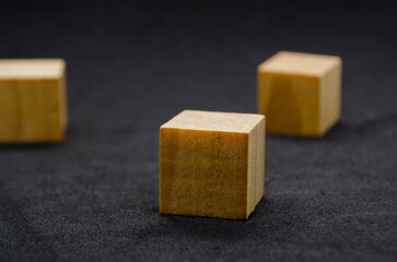 Isolated wooden cubes on dark background with customizable space for text or ideas.