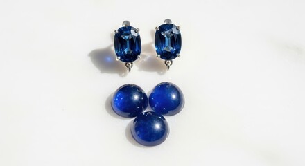 Exquisite blue gemstones and sapphire earrings on white background
