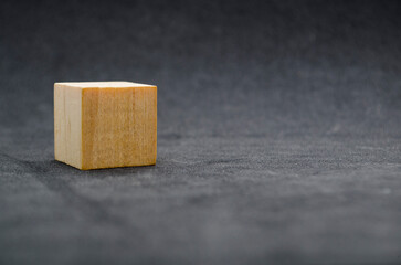 A single wooden cube with customizable space for text or ideas.