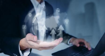 Businessman Holding Digital Earth Globe with Growth Arrows, Concept of Global Business Expansion, Corporate Success Strategy, Worldwide Investment, and Future Digital Technology Solutions.