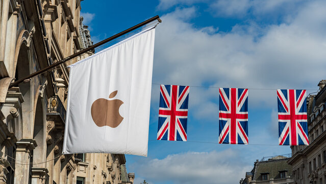 Apple flag outside retail store with Union Jack flags, 24 April, Central London, UK