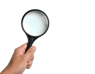 Hand holding magnifying glass, revealing details