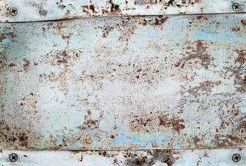 rusty metal plate with screws