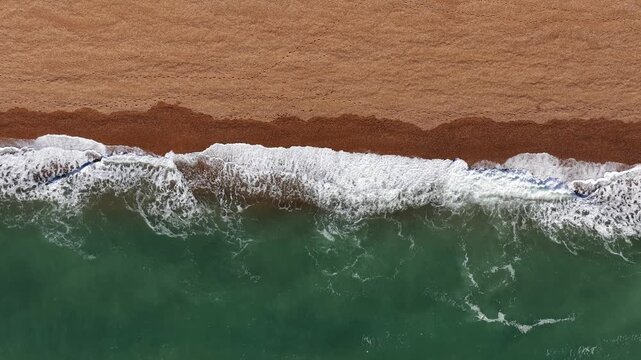 Waves crash at beach in Folkestone, United Kingdom.
