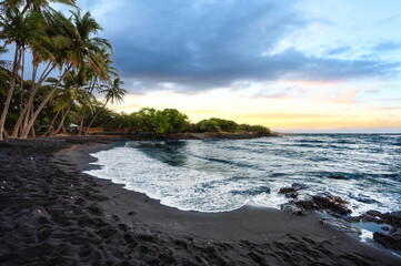 Punaluu black sand beach with palm trees and ocean waves, Big Island, Hawaii, United States