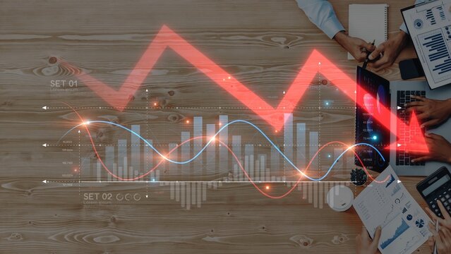 A modern office scene featuring hands analyzing data charts and graphs, depicting a business decline. Professionals collaborate on strategies with technology present. Raster