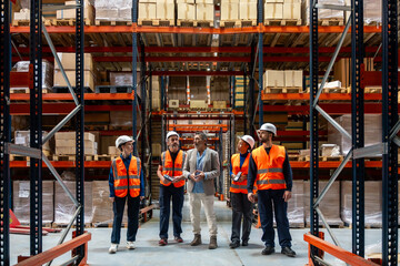Logistics team leader meeting with warehouse workers