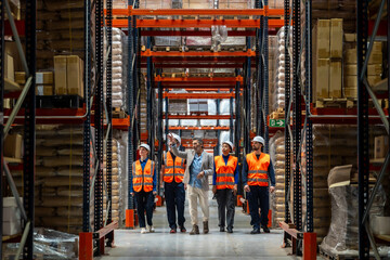 Warehouse manager leading team through logistics facility