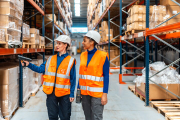 Female logistics workers scanning packages in warehouse