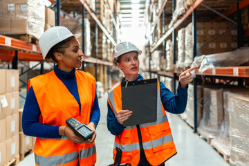 Female logistics workers discussing inventory in warehouse