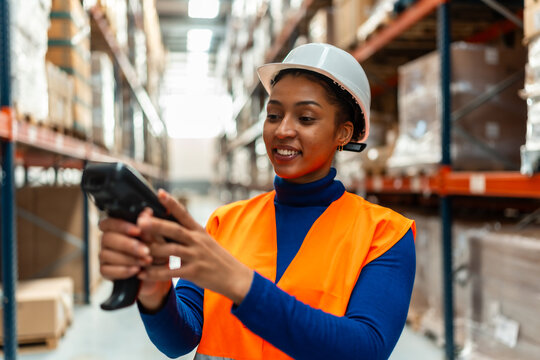 Woman worker scanning inventory in logistics warehouse - Powered by Adobe