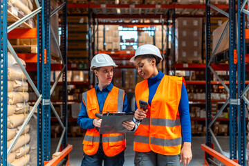 Female logistics workers checking inventory in warehouse