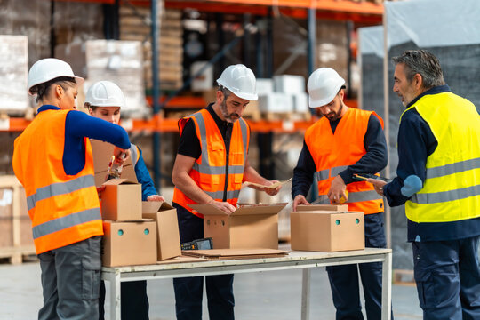 Warehouse workers packing boxes for shipping logistics