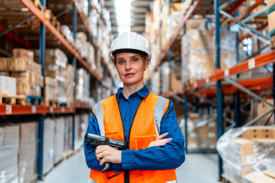 Woman logistics worker holding barcode scanner in warehouse