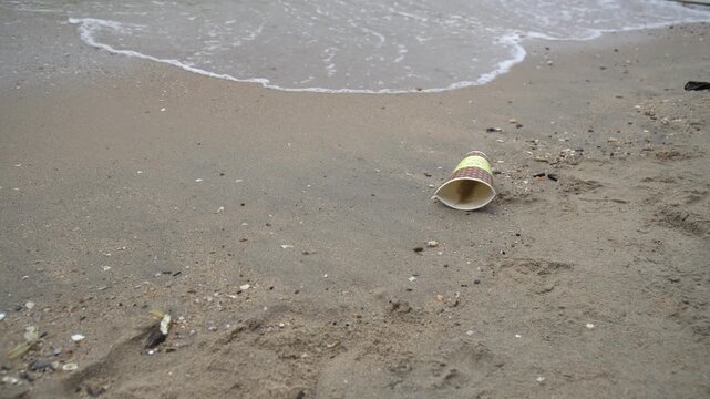 Paper cups are trash at the beach.