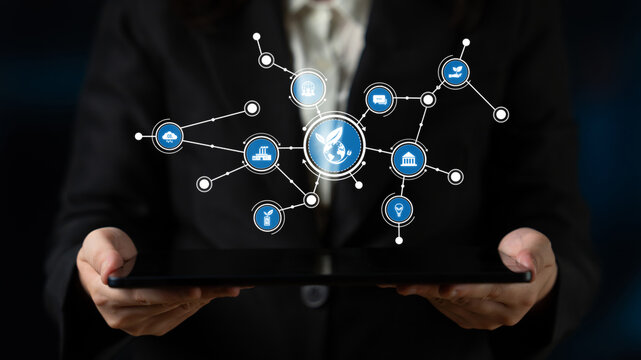 A business professional presents a tablet displaying a digital network, symbolizing the integration of technology and connectivity in the modern workplace. Tessel