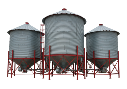 Isolated metal grain bins storing grain on a farm, red support structures, ladders, silver color