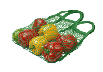 Isolated eco string bag filled with fresh bell peppers and green reusable grocery sack