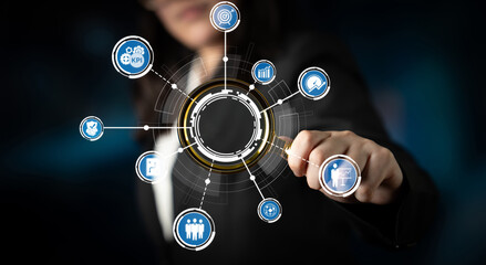 A businesswoman interacts with digital icons in a virtual hub, symbolizing data analysis and team collaboration, showcasing the future of modern business practices. Crux