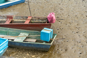Traditional Fishing Boats Resting on Mud at Low Tide