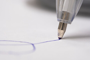 Close up of silver ballpoint pen on white background