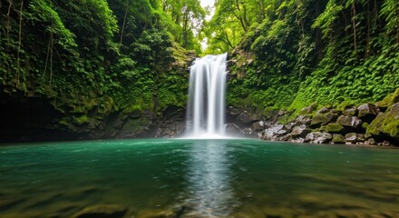 Fototapeta premium Cascading waterfall plunges into a vibrant turquoise pool, surrounded by lush green foliage (1)
