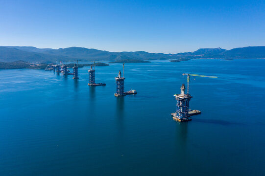 Aerial view of the bridge construction standing tall amidst the tranquil waters, a testament to human engineering prowess, Brijesta, Dubrovnik-Neretva County, Croatia.