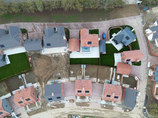 Drone view of a part completed new housing development site in rural Essex, UK. Both affordable and luxury family homes are on the Greenfield site.