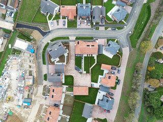 Abstract, top down view of newly completed detached and semi detached houses sene on a British housing development site. Note the newly laid lush lawns.
