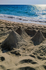 Pyramids made of sand on the beach