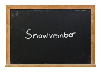 Snowvember written in white chalk on a black chalkboard isolated on a wooden frame